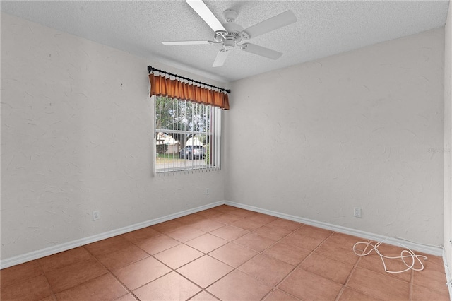 empty room with light tile patterned floors, a textured ceiling, and ceiling fan