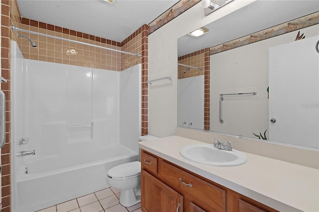 full bathroom with washtub / shower combination, tile patterned flooring, a textured ceiling, toilet, and vanity