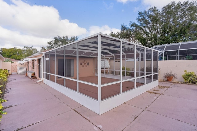 view of patio featuring a lanai