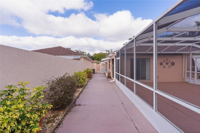 view of side of home featuring a lanai and a patio area