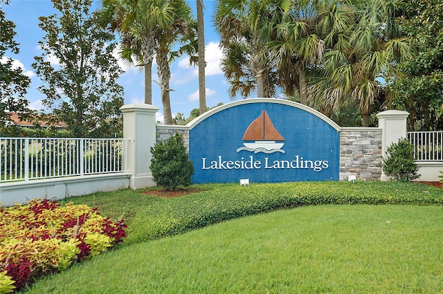 community / neighborhood sign with a lawn