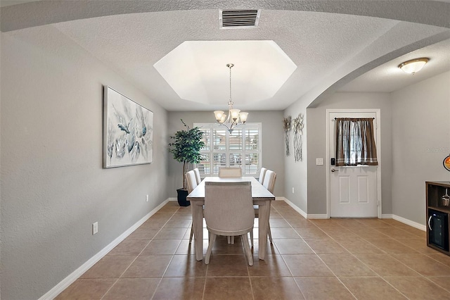 tiled dining space featuring an inviting chandelier