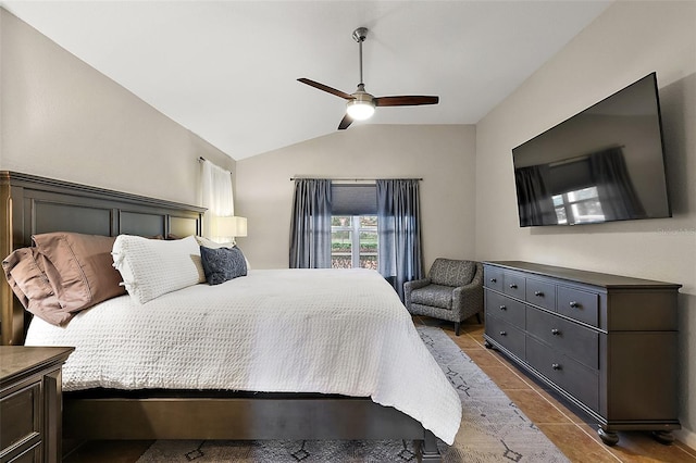 bedroom featuring ceiling fan, lofted ceiling, and light tile patterned floors