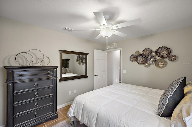 tiled bedroom featuring ceiling fan