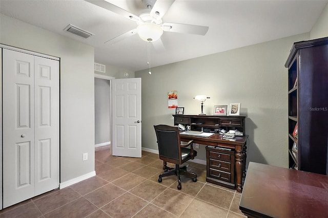 tiled home office featuring ceiling fan