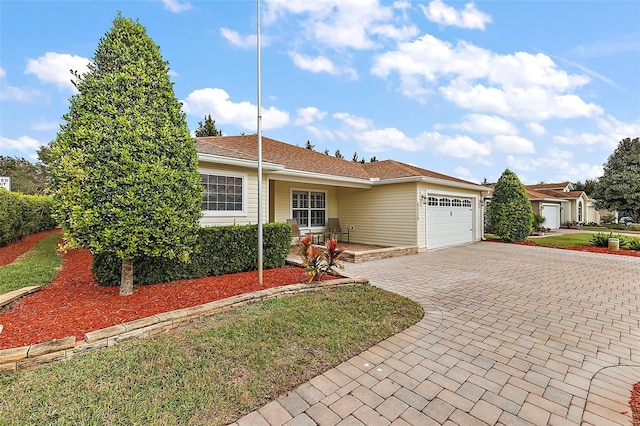 single story home featuring a porch and a garage