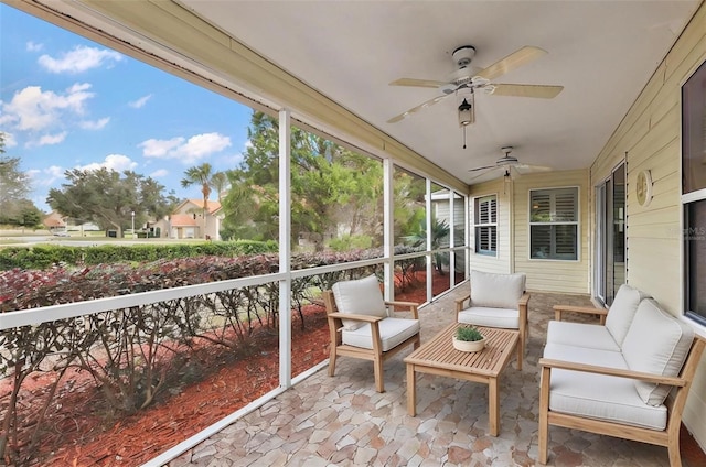 sunroom / solarium featuring ceiling fan