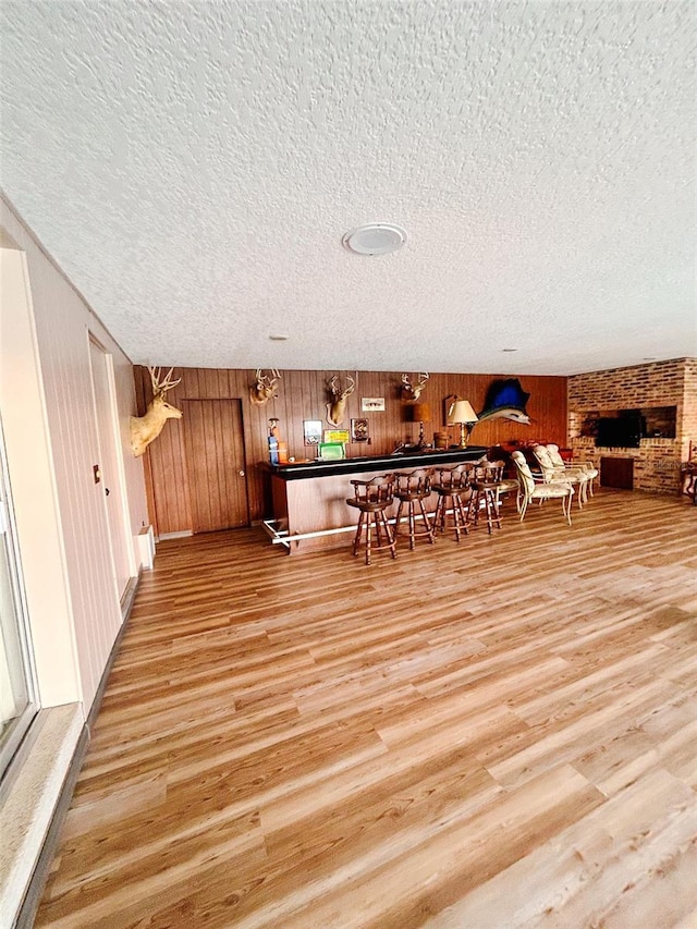 bar with wooden walls and wood-type flooring