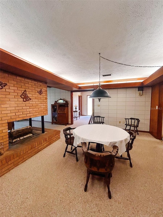 dining area featuring a fireplace and a textured ceiling