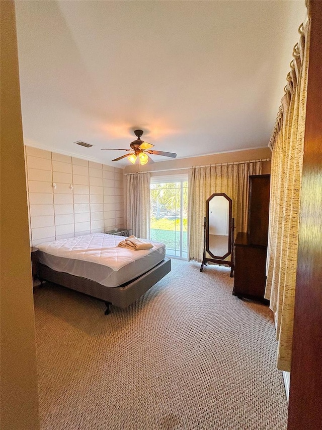 bedroom featuring carpet, ceiling fan, and access to outside