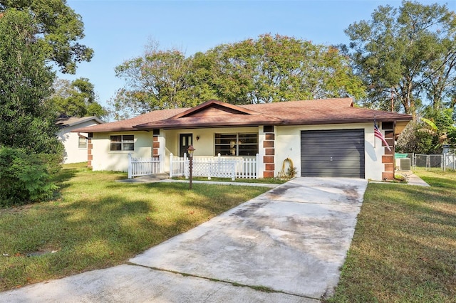 ranch-style house featuring a front lawn, a porch, and a garage