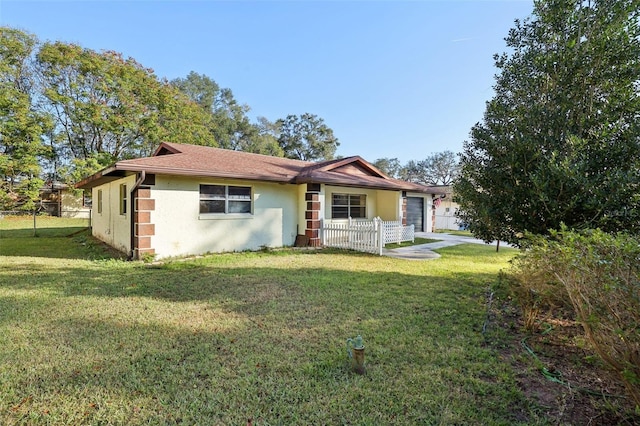 single story home with a front yard and a garage