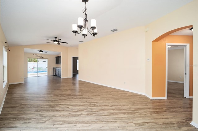 unfurnished living room with ceiling fan with notable chandelier, hardwood / wood-style floors, and lofted ceiling