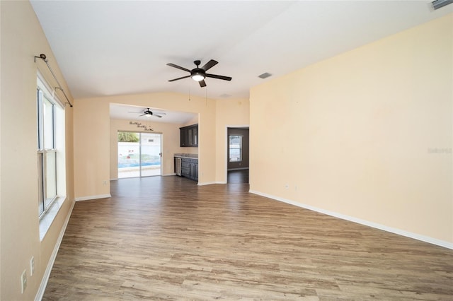 unfurnished living room with hardwood / wood-style flooring, ceiling fan, and lofted ceiling