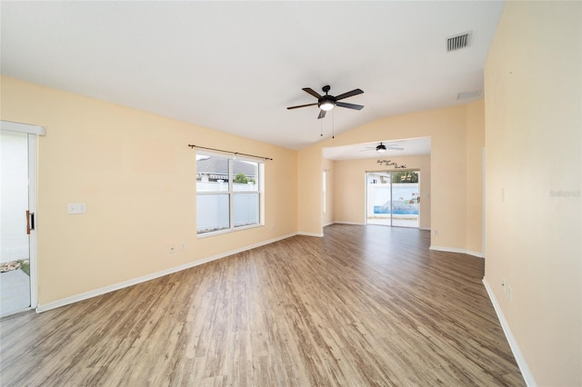 empty room with light hardwood / wood-style floors, ceiling fan, and vaulted ceiling