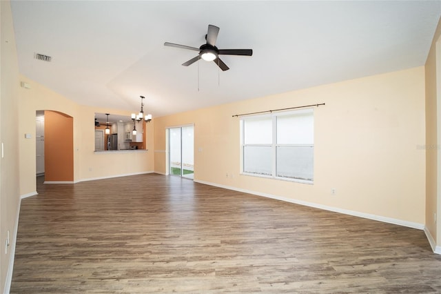 unfurnished living room with hardwood / wood-style flooring, ceiling fan with notable chandelier, and vaulted ceiling