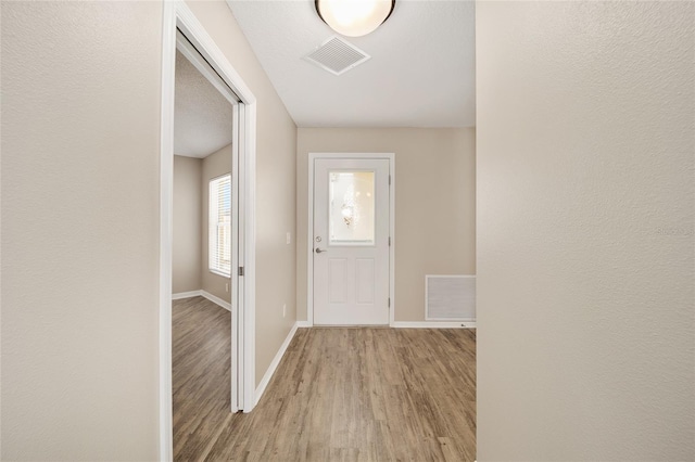 17159 SE 78th Crowfield Ave, The Villages, FL 32162 - hall with baseboards, visible vents, and wood finished floors