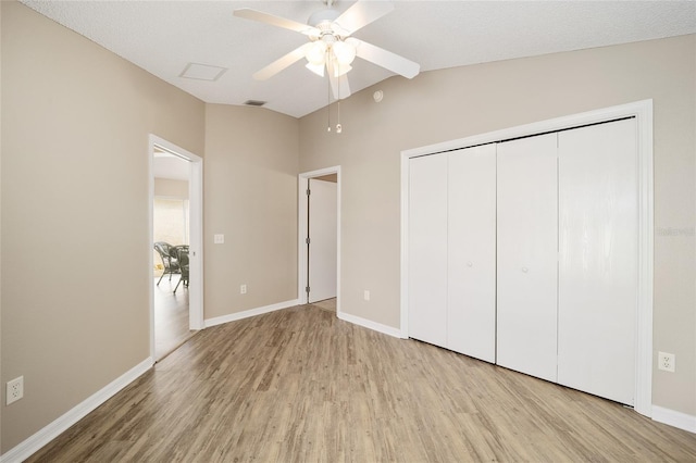 17159 SE 78th Crowfield Ave, The Villages, FL 32162 - unfurnished bedroom featuring a closet, visible vents, light wood-style flooring, baseboards, and vaulted ceiling