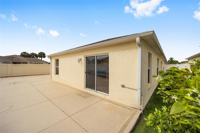 17159 SE 78th Crowfield Ave, The Villages, FL 32162 - rear view of property featuring a fenced backyard, stucco siding, and a patio