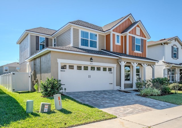 view of front of home with a front lawn and a garage