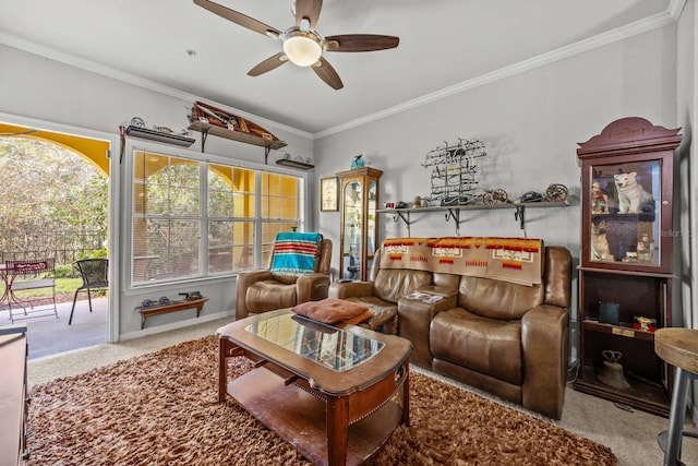 living room featuring carpet flooring, ceiling fan, and crown molding