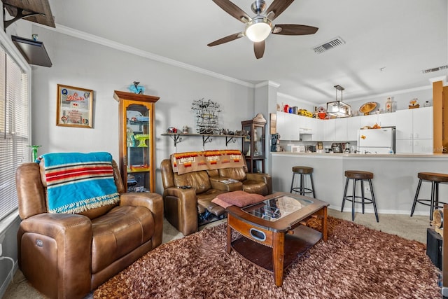 carpeted living room with ceiling fan and crown molding