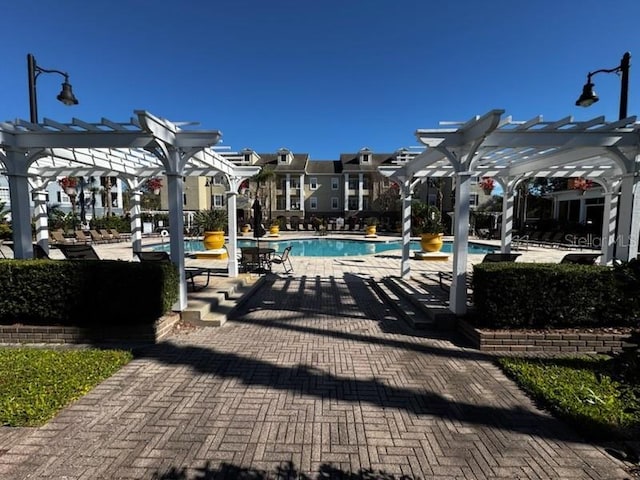 view of pool with a pergola and a patio