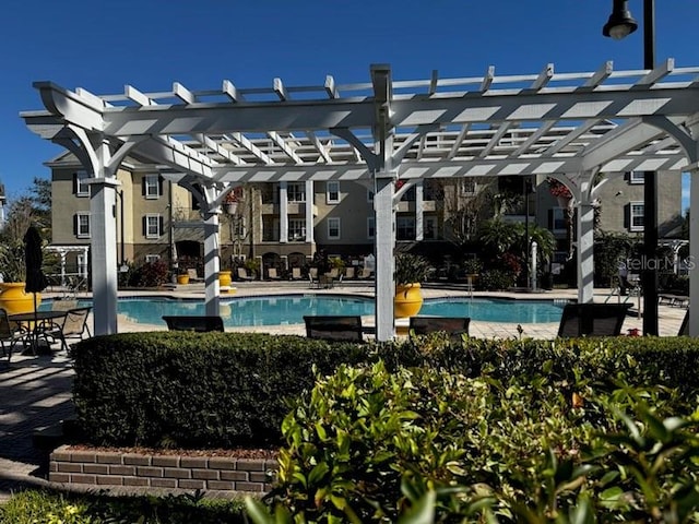 view of pool featuring exterior fireplace