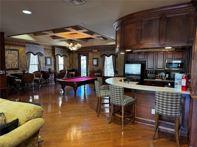 playroom with hardwood / wood-style floors, an inviting chandelier, coffered ceiling, billiards, and beam ceiling