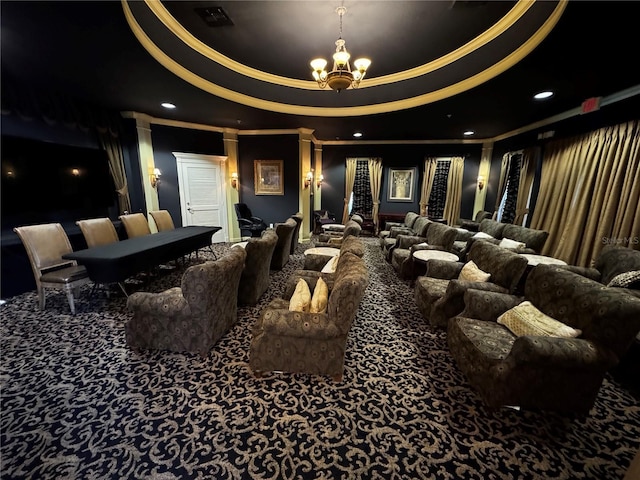 carpeted home theater featuring a raised ceiling and a chandelier