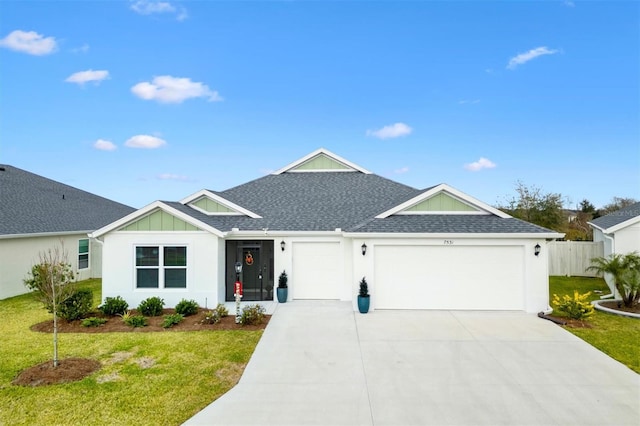 view of front facade with a front yard and a garage