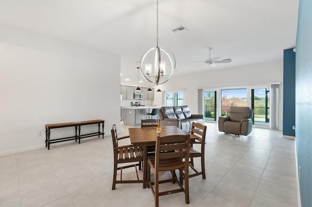 tiled dining area with ceiling fan with notable chandelier