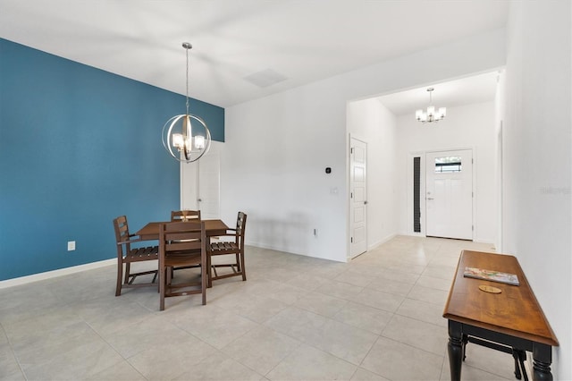 dining area with a notable chandelier and light tile patterned floors