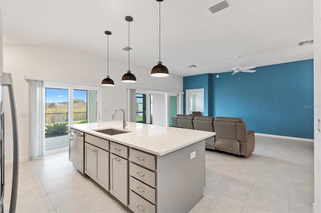 kitchen featuring ceiling fan, dishwasher, sink, an island with sink, and decorative light fixtures