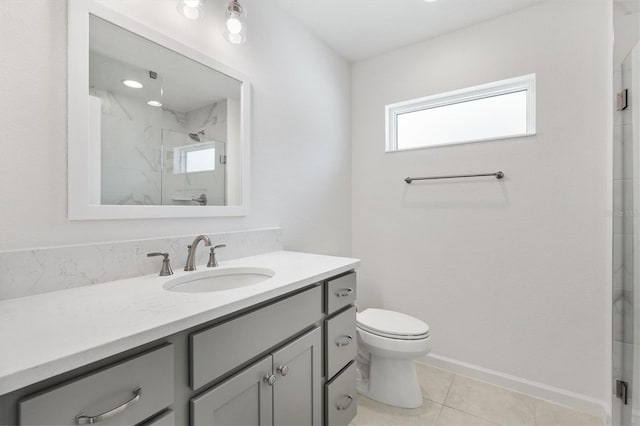 bathroom featuring tile patterned floors, a shower with door, vanity, and toilet