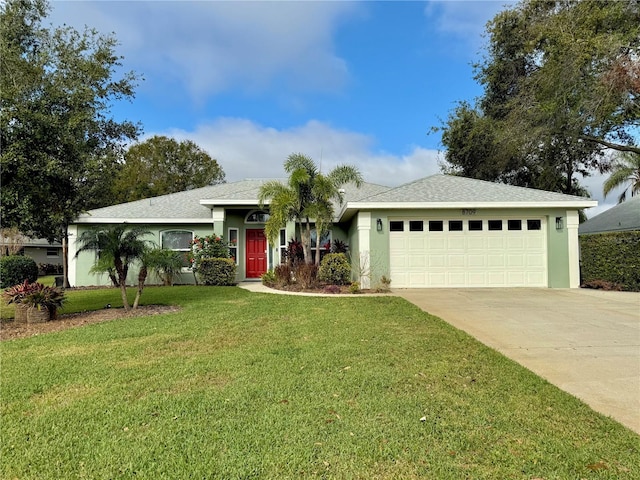 ranch-style house with a garage and a front lawn