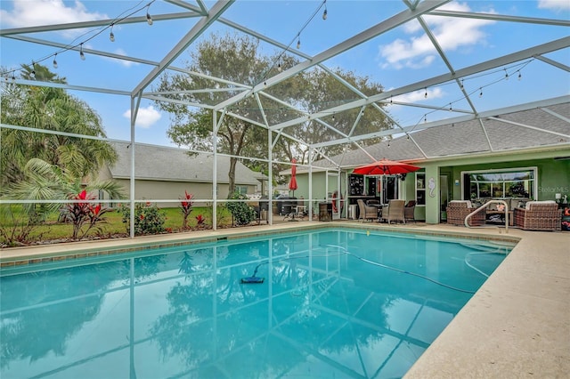 view of pool featuring a lanai, an outdoor hangout area, and a patio