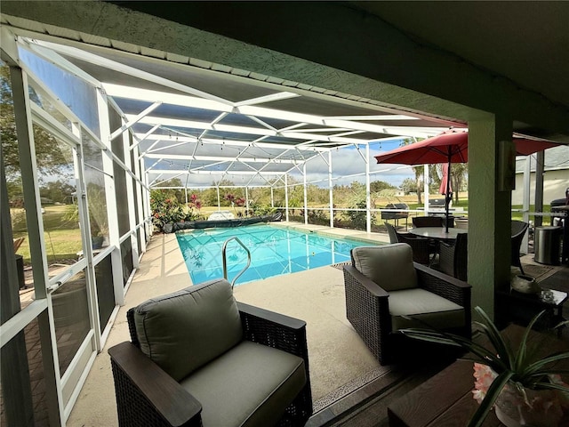 view of swimming pool featuring a patio area and glass enclosure