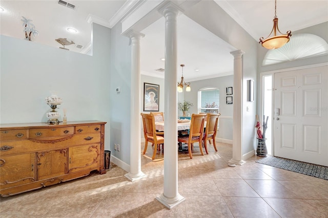 entryway featuring ornamental molding, decorative columns, and light tile patterned floors