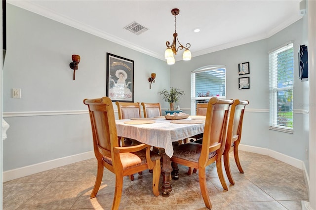 dining space with an inviting chandelier, crown molding, and light tile patterned flooring