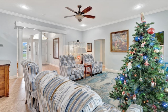 living room featuring light tile patterned floors, ornamental molding, decorative columns, and ceiling fan