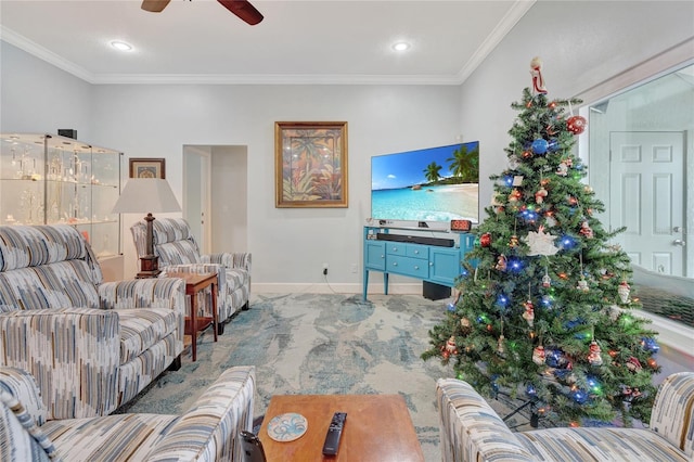 living room with carpet floors, ornamental molding, and ceiling fan