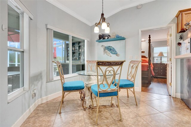 tiled dining room with crown molding and vaulted ceiling