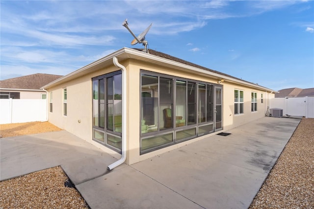 back of property with a patio and cooling unit