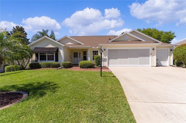 single story home with a garage and a front lawn