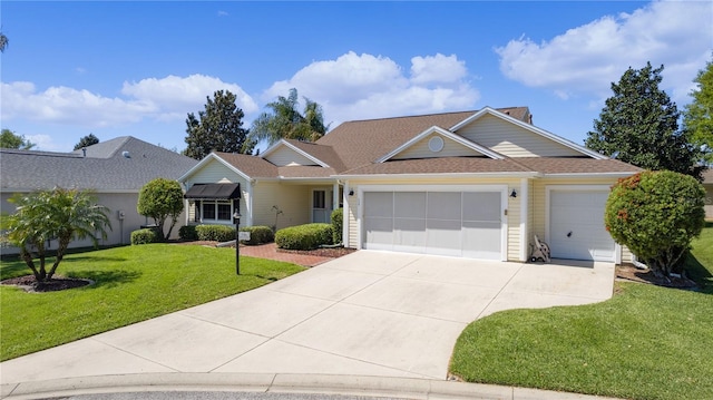 single story home with a garage and a front lawn