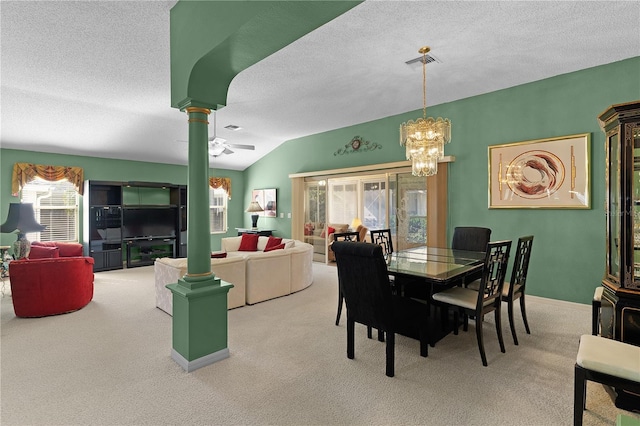 carpeted dining area featuring lofted ceiling, decorative columns, and a textured ceiling