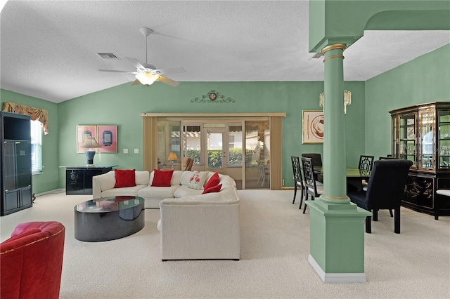 living room featuring ornate columns, lofted ceiling, light colored carpet, and a textured ceiling