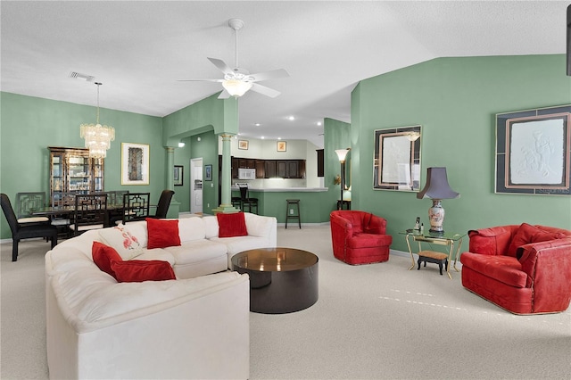 living room with lofted ceiling, ceiling fan with notable chandelier, a textured ceiling, and carpet flooring