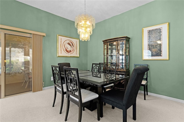 dining room featuring carpet flooring, a notable chandelier, and a textured ceiling